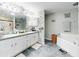 Modern bathroom with dual vanities, soaking tub, and walk-in shower at 8327 Sw 79Th Cir, Ocala, FL 34476