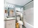 Well-lit bathroom featuring white cabinetry, shower/tub combo, and floral decor at 8327 Sw 79Th Cir, Ocala, FL 34476