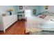 Guest bedroom with king-size bed, white dresser, and wood flooring at 8327 Sw 79Th Cir, Ocala, FL 34476