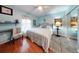 Cozy bedroom with large bed, mirrored closet doors, and wood-look flooring at 8327 Sw 79Th Cir, Ocala, FL 34476