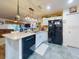 Well-appointed kitchen with breakfast bar, dishwasher, and black appliances at 8327 Sw 79Th Cir, Ocala, FL 34476