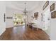 Bright dining room with wood floors, chandelier, and sliding glass doors to patio at 8585 Sw 82Nd Ter, Ocala, FL 34481