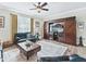 Relaxing living room with leather sofas, wood flooring, and a large TV at 8992 Sw 86Th Loop, Ocala, FL 34481