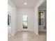 Front entry with glass-paned door and neutral tile floor at 9733 Sw 74Th Pl, Ocala, FL 34481