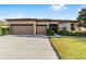 Single-story home with three-car garage and landscaped yard at 9733 Sw 74Th Pl, Ocala, FL 34481