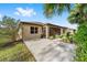Tan house exterior with screened patio and landscaped yard at 9733 Sw 74Th Pl, Ocala, FL 34481