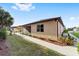Side view of house showcasing tan exterior and landscaping at 9733 Sw 74Th Pl, Ocala, FL 34481