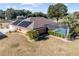 Home with solar panels, screened pool, and lush landscaping at 9901 Nw 6Th Ct, Ocala, FL 34475