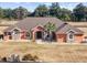 Ranch-style home with tile roof, large yard, and partial fence at 9901 Nw 6Th Ct, Ocala, FL 34475