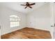 Spacious bedroom with wood flooring and large window at 9901 Nw 6Th Ct, Ocala, FL 34475