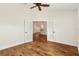 Bedroom with wood flooring and access to living area at 9901 Nw 6Th Ct, Ocala, FL 34475