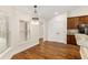 Spacious dining area with hardwood floors and elegant light fixture at 9901 Nw 6Th Ct, Ocala, FL 34475