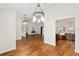 Bright dining room with hardwood floors and views into the living room and kitchen at 9901 Nw 6Th Ct, Ocala, FL 34475