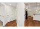 Light-filled hallway with wood flooring and access to other rooms at 9901 Nw 6Th Ct, Ocala, FL 34475