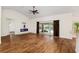 Bright living room with hardwood floors, fireplace, and sliding doors leading to the pool at 9901 Nw 6Th Ct, Ocala, FL 34475