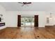Bright living room with hardwood floors and sliding doors to pool area at 9901 Nw 6Th Ct, Ocala, FL 34475