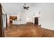 Open concept living space showcasing hardwood floors and kitchen access at 9901 Nw 6Th Ct, Ocala, FL 34475