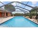 Inviting screened pool with rock waterfall feature at 9901 Nw 6Th Ct, Ocala, FL 34475