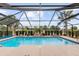 Relaxing screened pool surrounded by lush landscaping at 9901 Nw 6Th Ct, Ocala, FL 34475