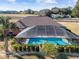 Screened in rectangular pool with surrounding landscaping at 9901 Nw 6Th Ct, Ocala, FL 34475