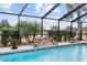 Relaxing screened pool with stone water feature at 9901 Nw 6Th Ct, Ocala, FL 34475