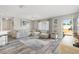 Bright living room with L-shaped sofa and wood-look floors at 10110 Se 179Th St, Summerfield, FL 34491