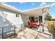 Covered patio with red chairs and table, adjacent to house at 10110 Se 179Th St, Summerfield, FL 34491