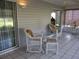 White wicker furniture on a spacious screened porch at 11495 Sw 138Th Ln, Dunnellon, FL 34432