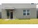 Back exterior view with sliding glass door and small yard at 1609 Chelsea Manor Cir, Deland, FL 32724