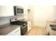 Modern kitchen with stainless steel appliances and granite countertops at 1609 Chelsea Manor Cir, Deland, FL 32724