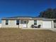 House exterior featuring a well-maintained lawn and a single-car garage at 17 Juniper Dr, Ocala, FL 34480