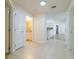 Bright hallway with tile floors, leading to bathroom and living spaces at 17066 Se 93Rd Yondel Cir, The Villages, FL 32162