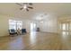 Bright living room with wood-look floors and access to the patio at 17066 Se 93Rd Yondel Cir, The Villages, FL 32162