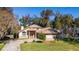 Two-story house with a large backyard, driveway, and beautiful landscaping at 1825 Se 36Th Pl, Ocala, FL 34471