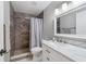 Modern bathroom with dark tile, white vanity, and a shower at 1825 Se 36Th Pl, Ocala, FL 34471
