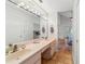 Bathroom with double vanity, large mirror, and tile floors at 1825 Se 36Th Pl, Ocala, FL 34471