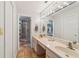 Bathroom with double vanity, large mirror, and tile floors at 1825 Se 36Th Pl, Ocala, FL 34471