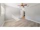 Light-filled bedroom with wood-look floors and access to another room at 1825 Se 36Th Pl, Ocala, FL 34471