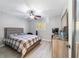Bright bedroom with wood-look floors, ceiling fan, and built-in closet at 1825 Se 36Th Pl, Ocala, FL 34471