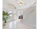 Large entryway with tiled floors, a staircase, and double doors with glass panels at 1825 Se 36Th Pl, Ocala, FL 34471