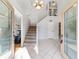Bright and spacious entryway with tiled floors, staircase, and double doors at 1825 Se 36Th Pl, Ocala, FL 34471