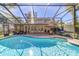 Inviting pool area with screened enclosure and patio furniture at 1825 Se 36Th Pl, Ocala, FL 34471