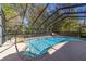 Inviting screened pool and spa with waterfall feature at 1825 Se 36Th Pl, Ocala, FL 34471
