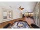 Sunroom with wood-look floors, game table, and TV at 1825 Se 36Th Pl, Ocala, FL 34471
