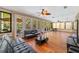 Sunroom with pool view, wood floors, and ample seating at 1825 Se 36Th Pl, Ocala, FL 34471