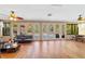 Sunroom with wood floors, access to the pool, and comfy seating at 1825 Se 36Th Pl, Ocala, FL 34471