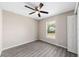 Bright bedroom featuring wood-look floors and ceiling fan at 23518 Sw Marine Blvd, Dunnellon, FL 34431