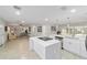 Modern kitchen with white cabinets, quartz countertops and island at 4328 Ne 12Th St, Ocala, FL 34470