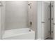 Clean bathroom with a shower/tub combo and tile surround at 6366 Sw 153Rd Lane Rd, Ocala, FL 34473