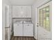 Laundry room with white cabinets, washer, and dryer at 722 Ne 21St Ave, Ocala, FL 34470